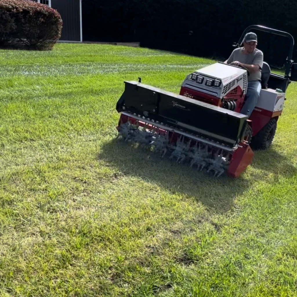 Outdoor Organics professional, aerating lawn for customer.