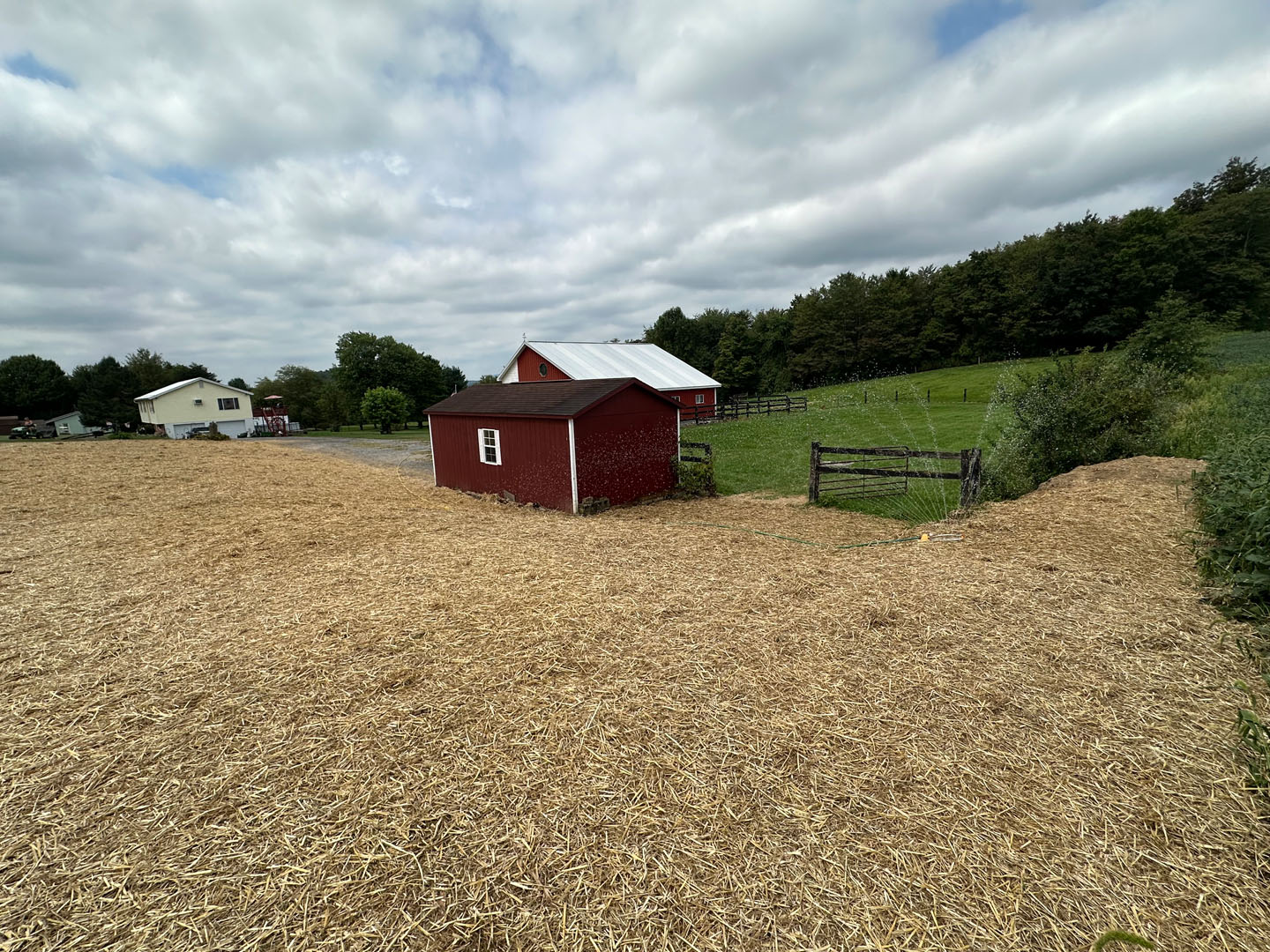 Red barn shed after finish grading and seeding.