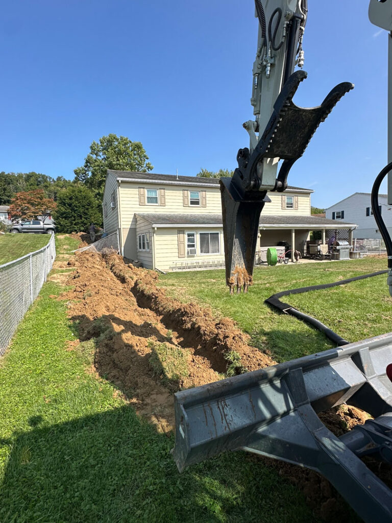 We installed a French drain strategically placed and connected to a corrugated pipe that channels water underground to the rear of the property.