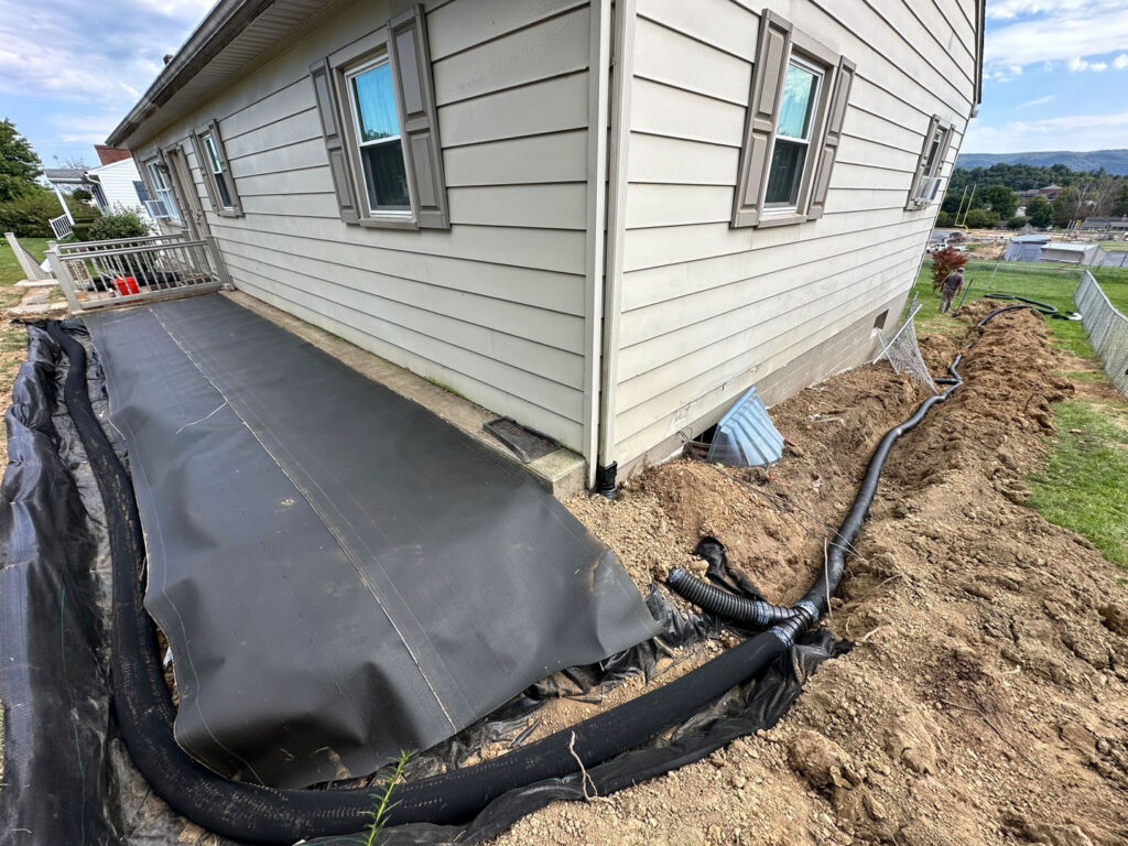 To reinforce the water diversion, we used a non-permeable material near the foundation.