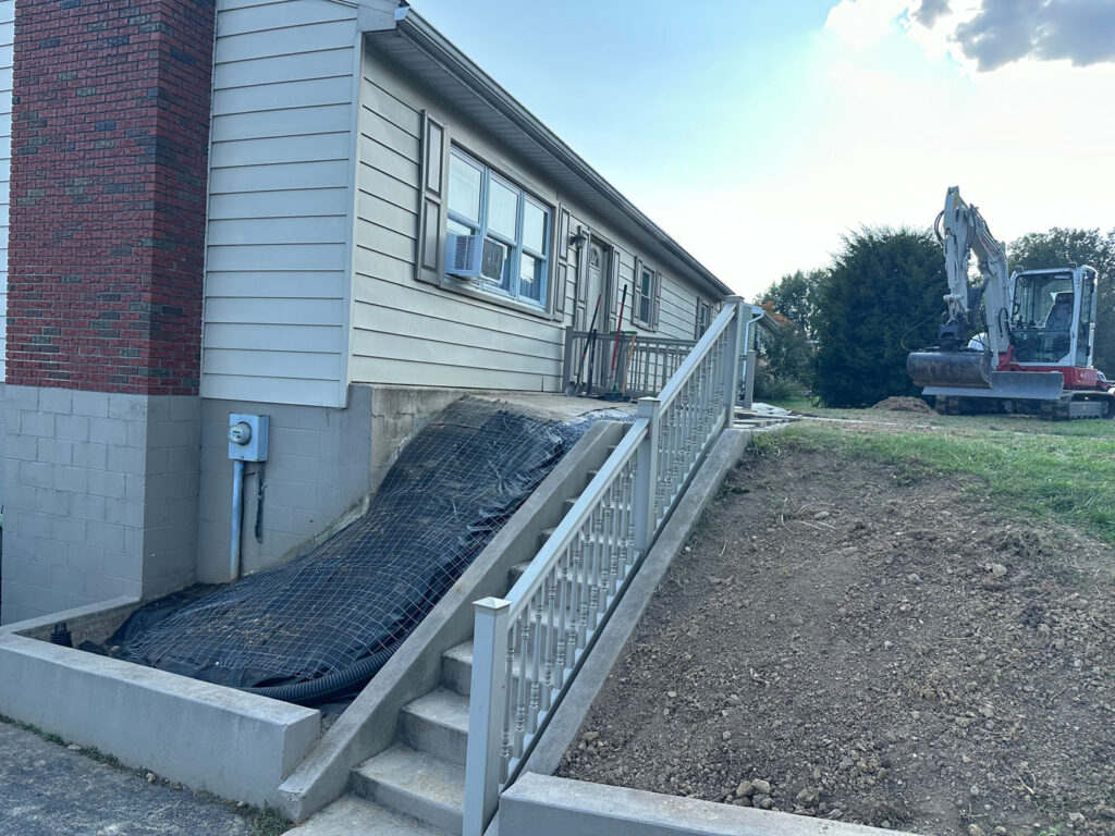 River rock was placed near the home and over the drain to create an appealing look.