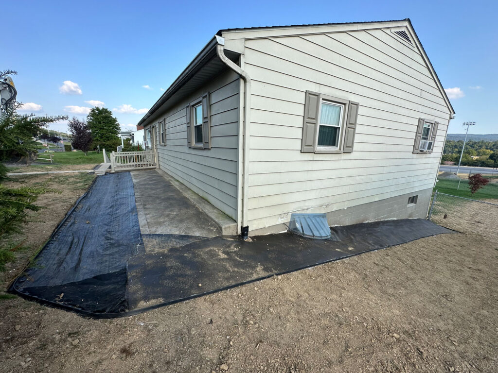 River rock was placed near the home and over the drain to create an appealing look.